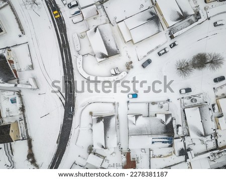 Aerial view of snow covered streets and roads during a blizzard (Wales)