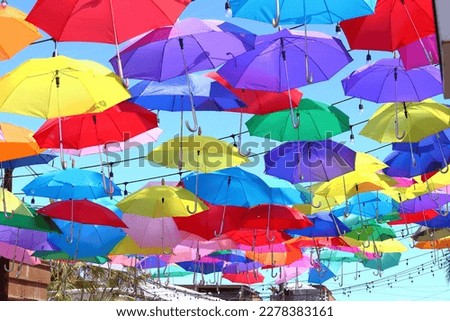 Multicolor umbrellas hanging to decorate a street