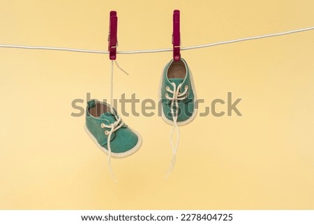 Baby shoes hanging on the clothesline. Newborn concept Royalty-Free Stock Photo #2278404725