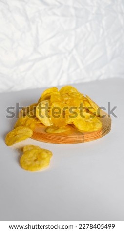 Golden Brown Banana Chips on the Wooden Background
