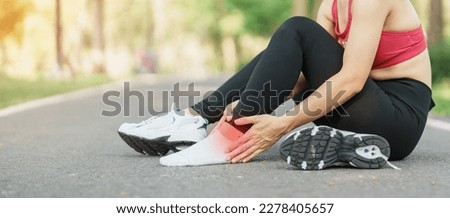 Young adult female with his muscle pain during running. runner woman having leg ache due to Ankle Sprains or Achilles Tendonitis. Sports injuries and medical concept Royalty-Free Stock Photo #2278405657