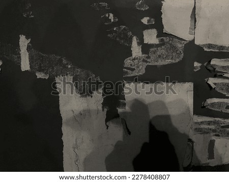 Photo of Former rips advertisements banner on the wall mixed with shadow people and object. Make Pattern Abstract of #uniquesself