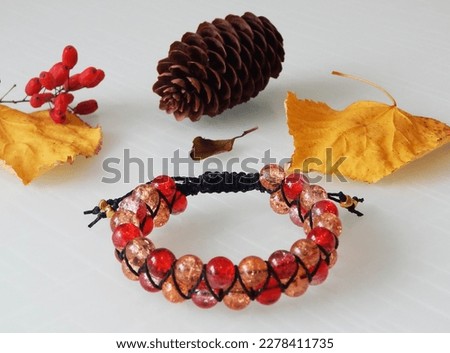 Hippie colorful bracelet on a white. Red bracelet on a white background