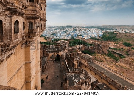 Top view of Mehrangarh fort with distant view of blue city Jodhpur, Rajasthan, India. Blue sky with white clouds in the background. Historical Fort is UNESCO world heritage site Royalty-Free Stock Photo #2278414819