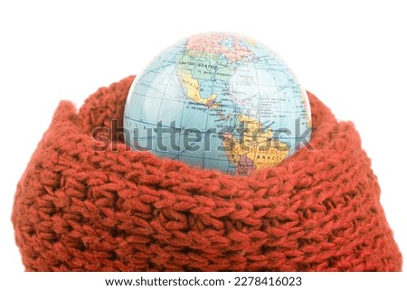 earth world globe in a warm scarf on a white background. global warming of the atmosphere. world weather