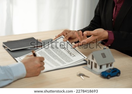 Businessman, insurance salesman explaining details in a purchase or lease contract Before the client signs the contract, the document agrees on the concept of security, investment