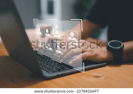 Man uses laptop with mind map - organigram on virtual screen. HR Manager works on HR org. Diagram, resource leveling, career concept. Royalty-Free Stock Photo #2278426697