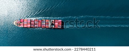top view Cargo Container Ship with Tug boat carrying container and running very fast for export import cargo from container yard port to custom ,Contrail line in the ocean