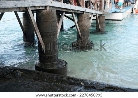 Serene view of sea dock pillars in the water stretching into the sea in Bali, Indonesia