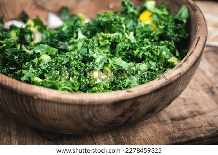 Chopped curly kale in wooden bowl