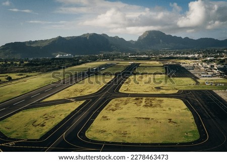 Aerial view of the runway and plane hangars of Lihue airport on Kauai island, Hawaii, United States - sep 2022. High quality photo Royalty-Free Stock Photo #2278463473