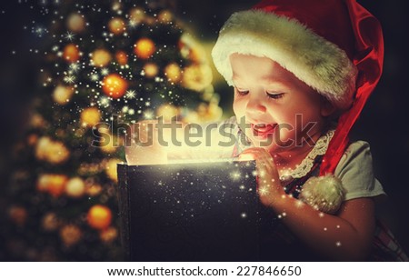 Christmas miracle, magic gift box and a child baby girl 