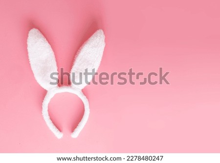 Easter mock up with ears rabbit on pink background, copy space, flat lay, top view