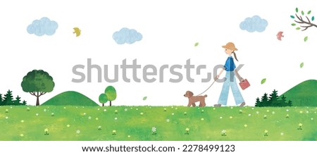 Woman walking with dog in grasslands