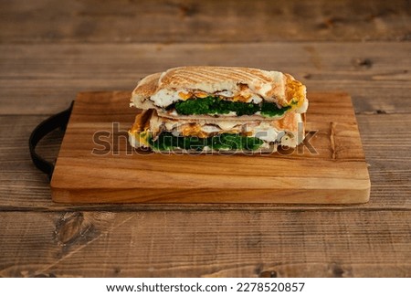 Hot Sandwich with Bacon, Cheese, Spinach and Egg