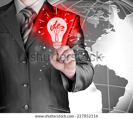 Business man touching light of idea