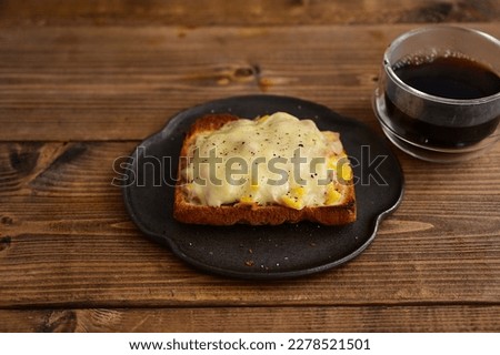 Grilled toast with tuna, cheese and corn on the cob, and coffee