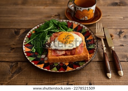 Open sandwich with fried egg and bacon