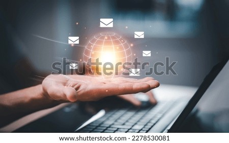 Business people hold a virtual world with communication icons, letter icons, email icons, and newsletter email and protect your personal information or spam mail, Customer service call center contact.