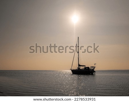 Backlit sailboat by sunshine on a sunny day, Waddensea, Netherlands