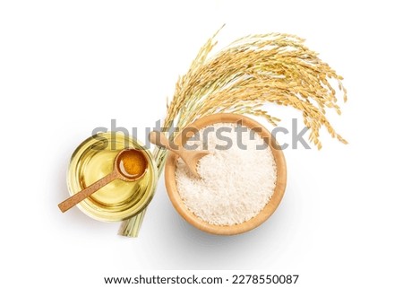 Rice bran oil extract with paddy and white rice on white background. Top view. Flat lay. Royalty-Free Stock Photo #2278550087