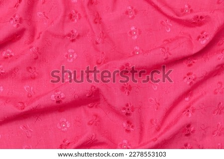Mauled dark pink colored fabric texture background. This fabric is made of cotton and polyester fibers.
