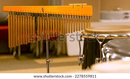 Musical instrument with blurry drum background. Selective focus. Edited in vintage filter