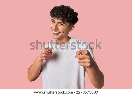 Young latin man pointing to front with fingers. Royalty-Free Stock Photo #2278573809