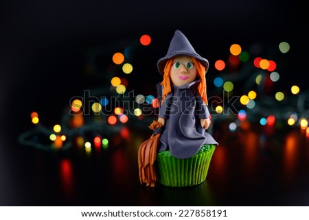 Halloween cupcake decorated with sugar witch. Open aperture and bokeh effect.