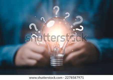Glowing lightbulb and question mark with copy space for creative thinking idea and problem solving concept. Royalty-Free Stock Photo #2278587971