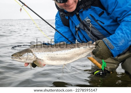 Happy angler with nice sea trout Royalty-Free Stock Photo #2278595147