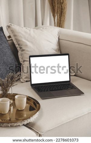 Lifestyle photo mockup of new trendy laptop with empty white screen in beige neutral scandinavian room for paste own social media, web site design and other for presentation for business and sell 