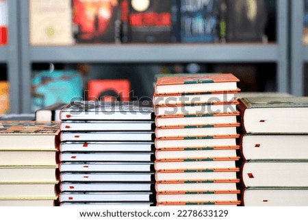 Books, notebooks, notepads lie on bookstore showcase, in library against background of shelves with book Royalty-Free Stock Photo #2278633129