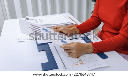 Close-up shot of busy woman paying bills online on computer to calculate household finances or taxes on the machine.
