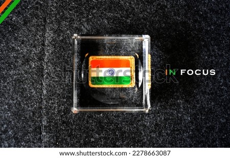 India in focus with concept of GDP growth with Indian flag placed in closeup with glass square.