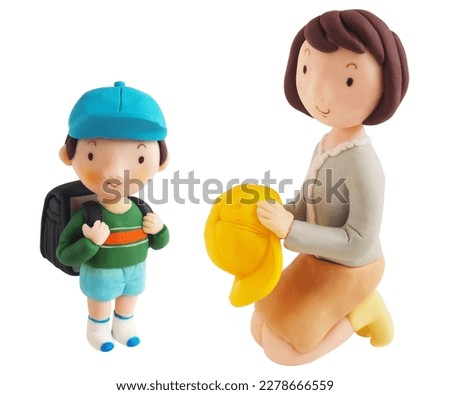 A happy boy and his mother carrying his school bag(This is a photo of a clay work)