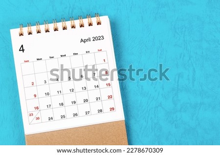 April 2023 Monthly desk calendar for 2023 year on blue background. Royalty-Free Stock Photo #2278670309