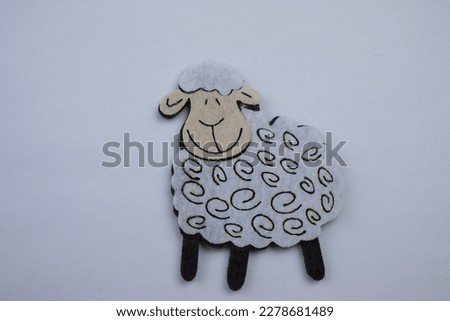 Sheep made of felt, sheep made of white felt, placed on a white background.