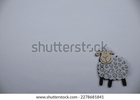 Sheep made of felt, sheep made of white felt, placed on the edge of a white background.