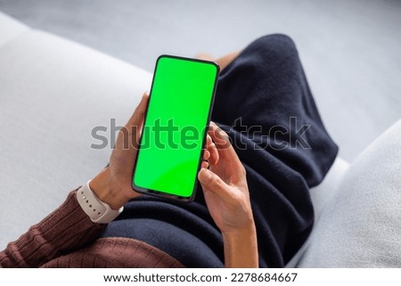 Woman hold with cellphone with green screen