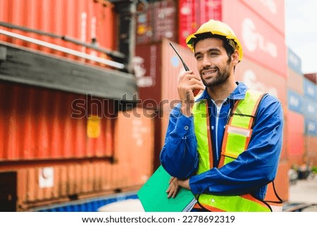 Industrial engineer worker working at overseas shipping container yard Royalty-Free Stock Photo #2278692319
