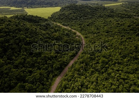 Aerial photo of a portion of the Hummingbird Highway, surrounded by jungle, in Belize