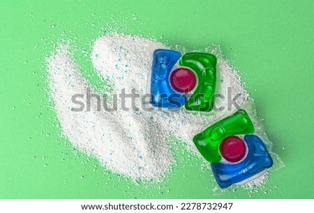 Washing powder and capsules for washing on a green background