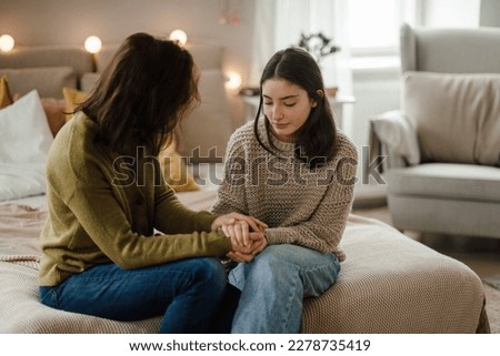 Teenage girl sharing problems with her mother. Royalty-Free Stock Photo #2278735419