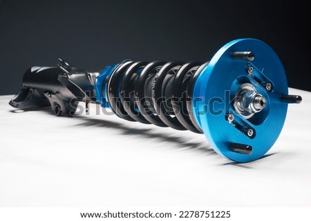 auto suspension tuning coilovers shock absorbers and springs blue for a sports drift car on a white background Royalty-Free Stock Photo #2278751225