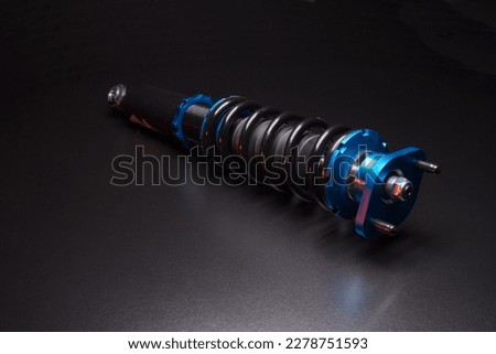 auto suspension tuning coilovers shock absorbers and springs blue for a sports drift car on a dark background Royalty-Free Stock Photo #2278751593