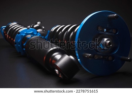 auto suspension tuning coilovers shock absorbers and springs blue for a sports drift car on a dark background Royalty-Free Stock Photo #2278751615