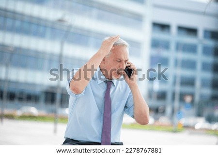 Angry senior business man yelling at the phone outdoor Royalty-Free Stock Photo #2278767881