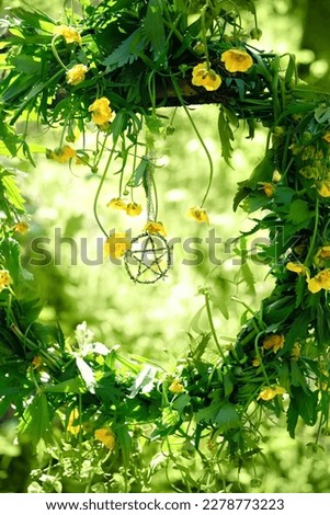 floral wreath with pentagram amulet in forest, green natural abstract background. wiccan magic ritual. Mysticism, occultism concept. witchcraft esoteric ritual for spring season. template for design Royalty-Free Stock Photo #2278773223