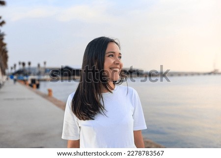 young girl smiling and looking the horizon